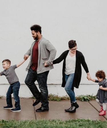 image of a family holding hands